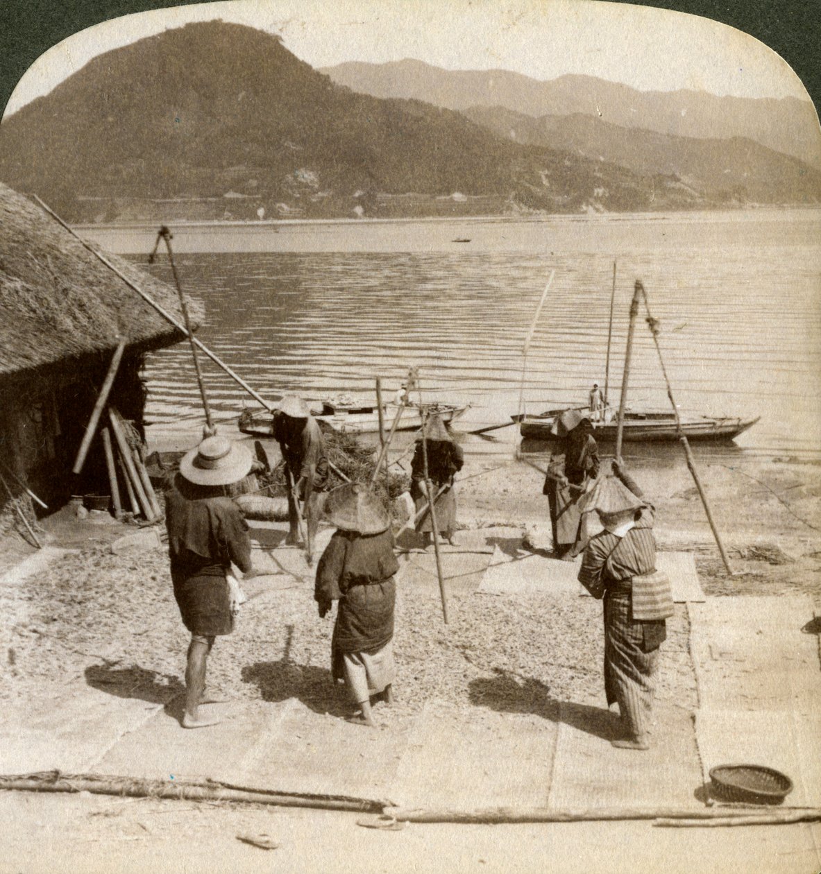 Flailing Barley Beside a Fishing Beach on the Inland Sea, Japan by Underwood and Underwood