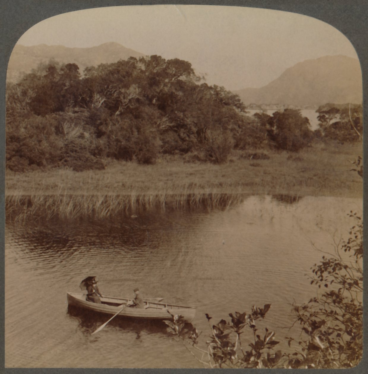 On the Upper Lake of pretty Killarney, Ireland by Underwood and Underwood