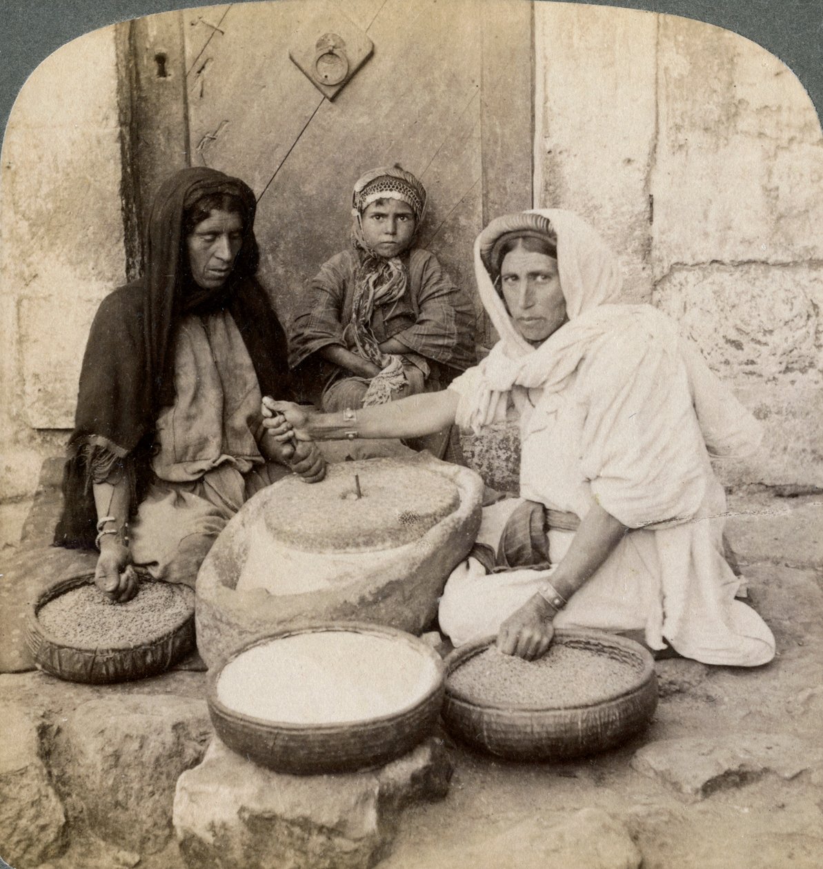 Women Grinding at the Mill, Palestine by Underwood and Underwood