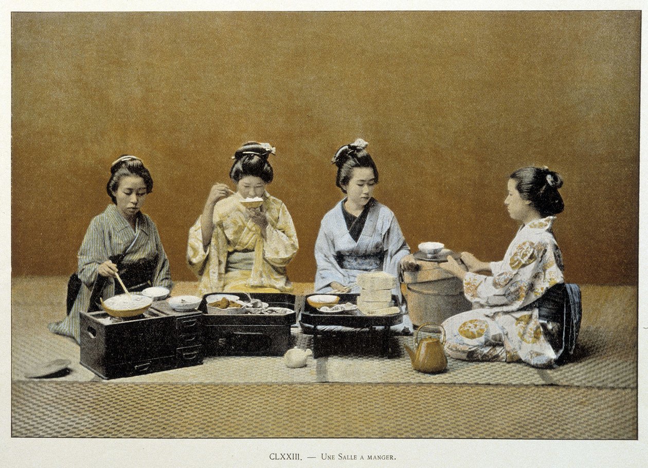 A dining room in Japan: women eating rice with chopsticks and one of them serving tea by Unknown artist