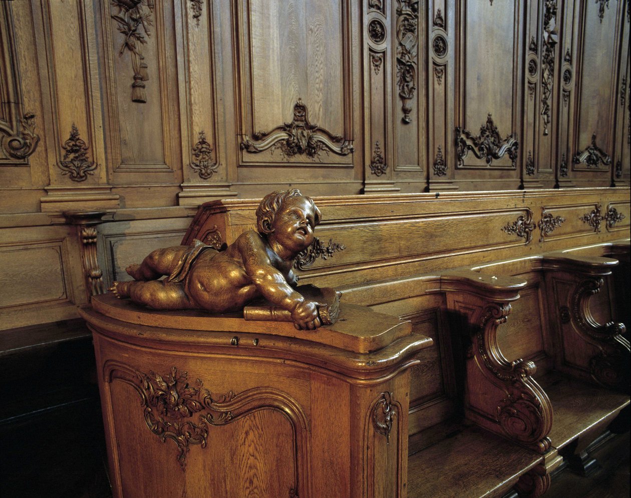 Baroque architecture: wooden stall representing an angel, attribute of the evangelist Saint Matthew. Choir (18th century) of the Church of St. Stephen. Internal view. Marmoutier, Bas Rhin by Unknown artist