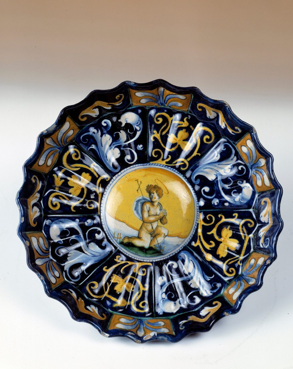Godronnee faience cup decoree of an angelot by Unknown artist
