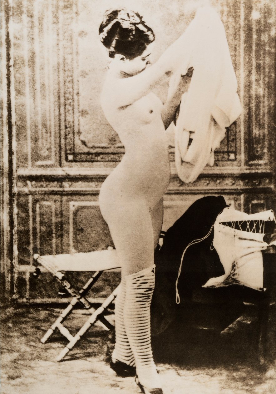 Full-length nude portrait of a young woman dressing by Unknown photographer