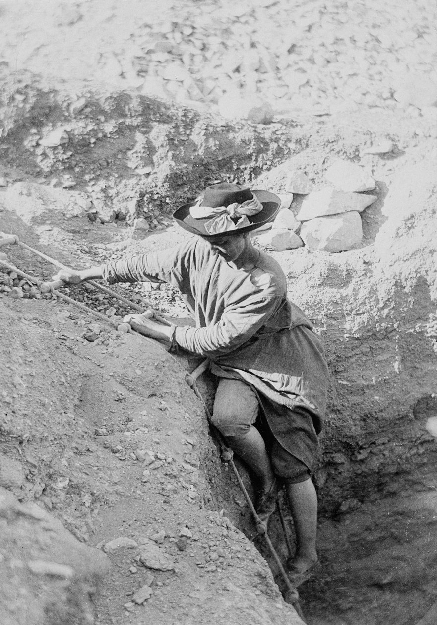 Hilda Petrie (née Urlin) descending by rope ladder into a tomb shaft, Possibly at Denderah by Unknown photographer