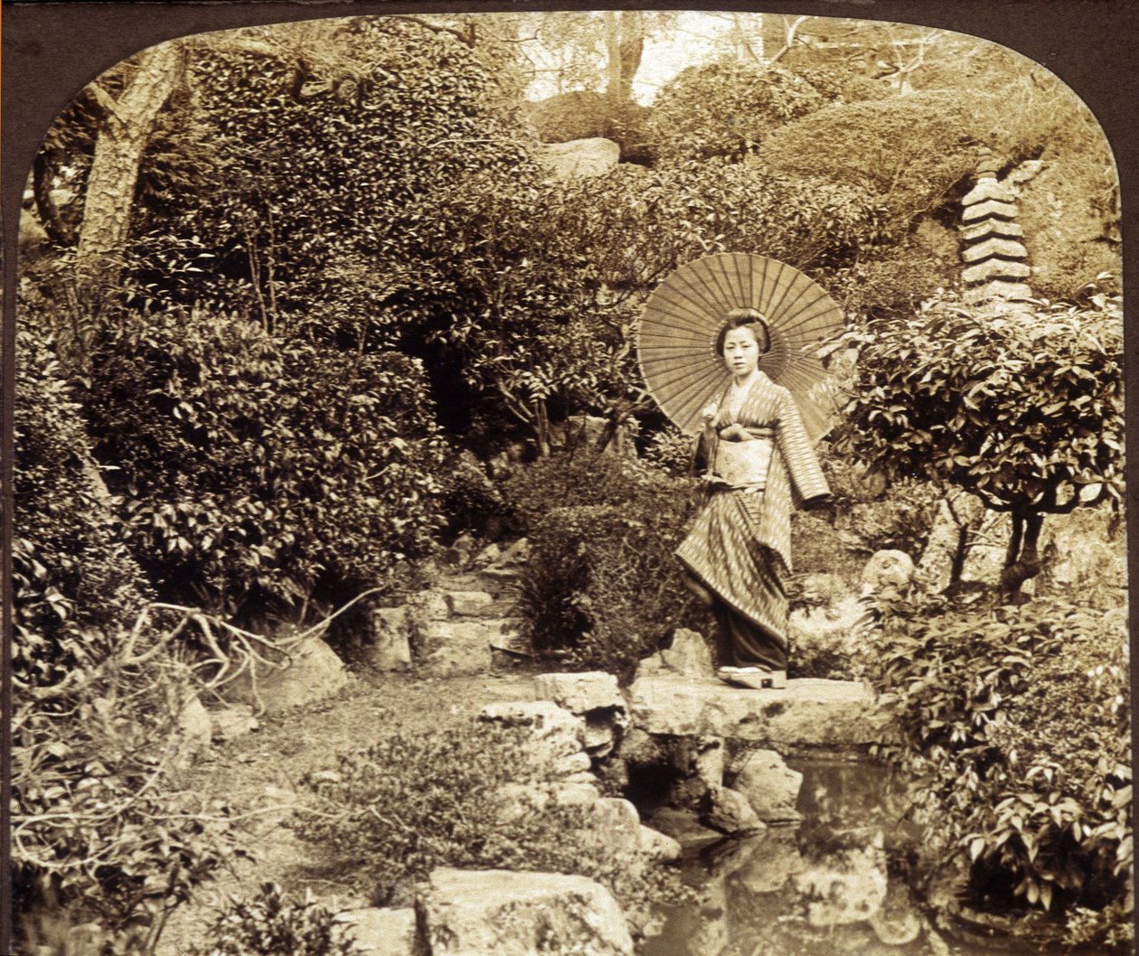 Japanese kimono umbrella in a garden - photography, late 19th century by Unknown photographer