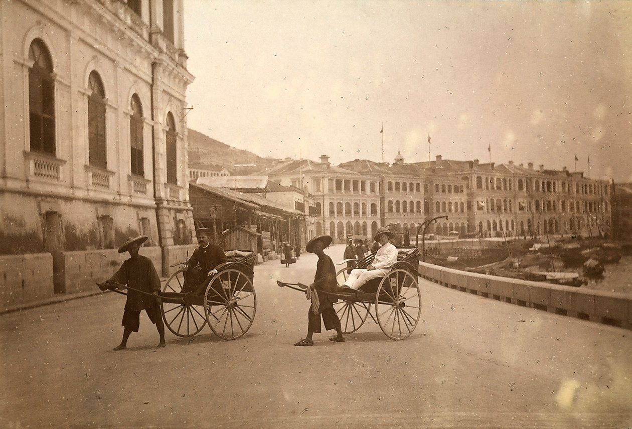 Two men carried by rickshaw in Hong Kong by Unknown photographer