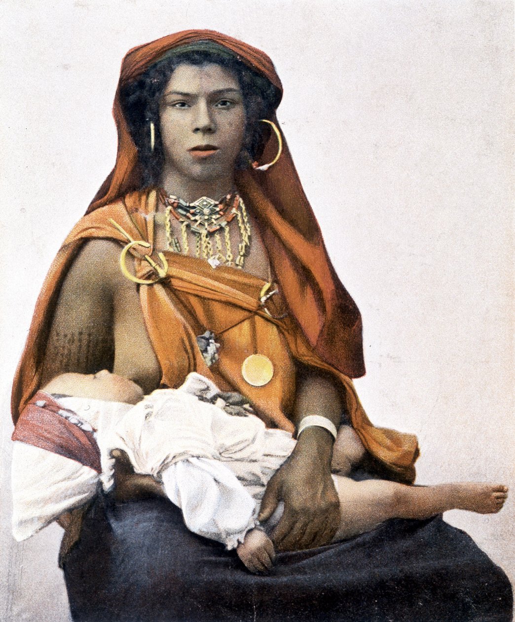 Young Berber woman breastfeeding a baby by Unknown photographer