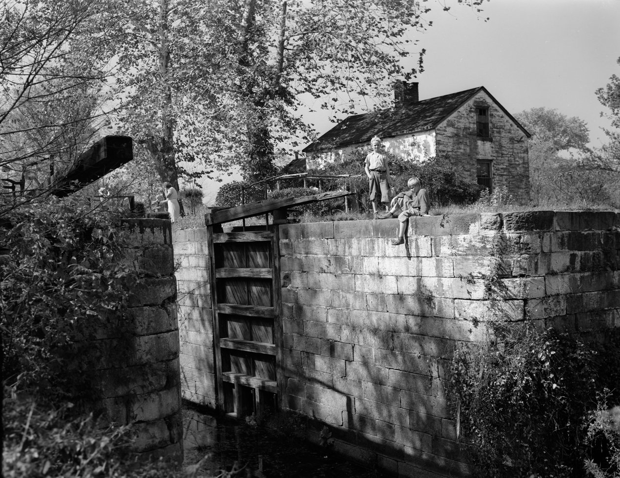 Antique lock on or near the Potomac River is viewed by boys by Volkmar Wentzel