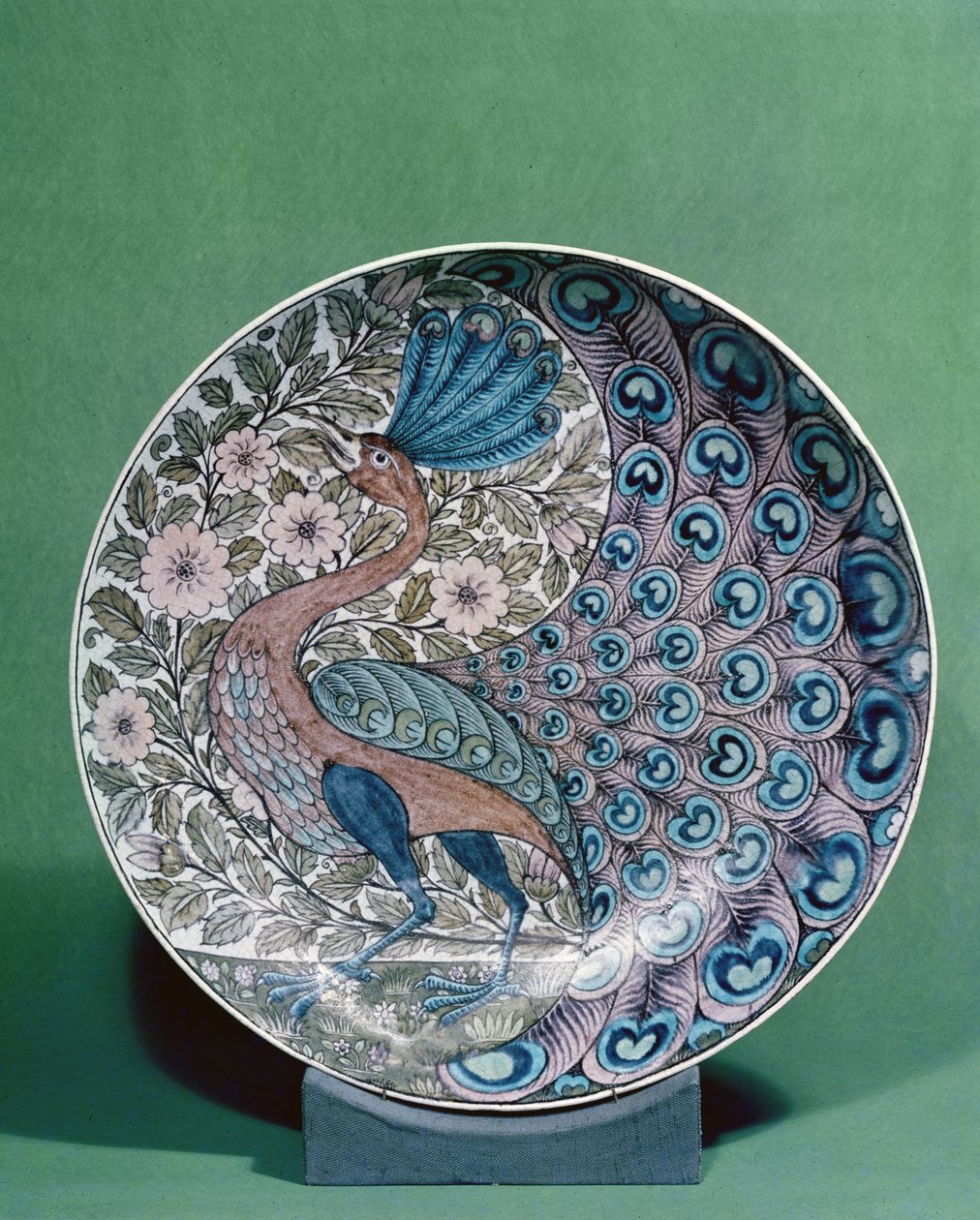 Earthenware dish with a peacock pattern by William de Morgan