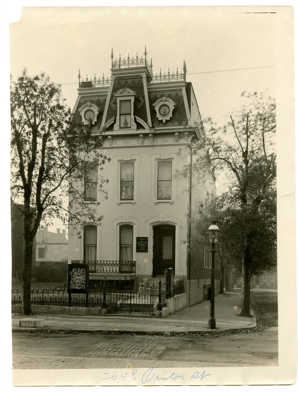 Three Story Stone and Brick Residence with Wrought Iron Railing on the Roof and Dormer Windows by William G. Swekosky