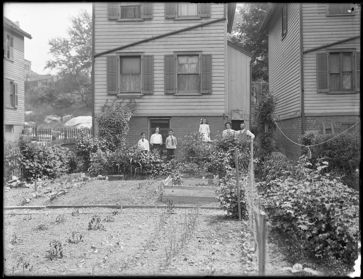 Family poses beside their backyard vegetable garden, Inwood, New York, c.1910 by William Davis Hassler