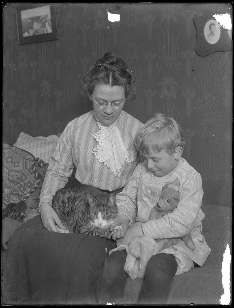 Harriet E. Hassler and William Gray Hassler, seated with tabby cat (Reddy) and teddy bear, c.1911 by William Davis Hassler