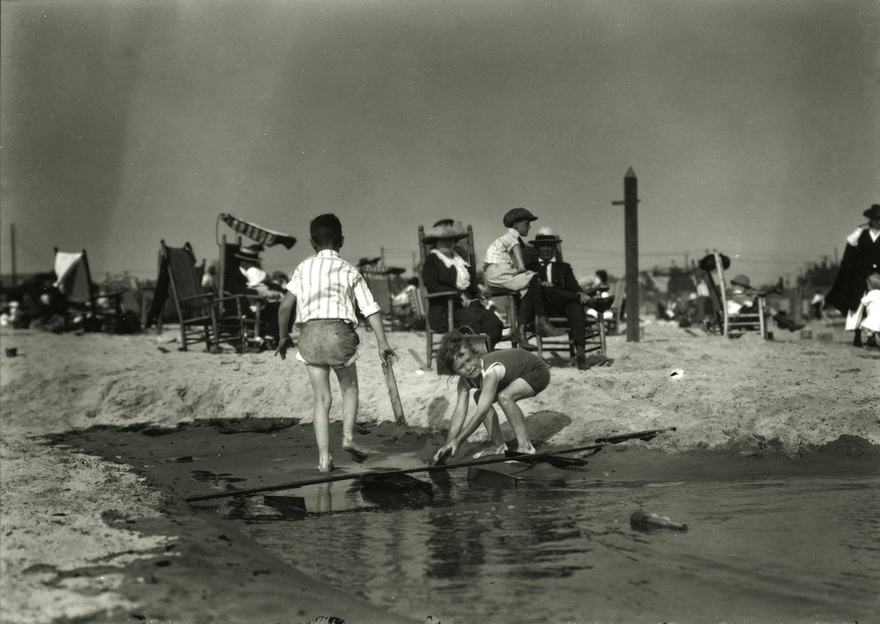 Two Children Play with Wood Scraps in Shallows, Coney Island, c.1910-21 by William Davis Hassler