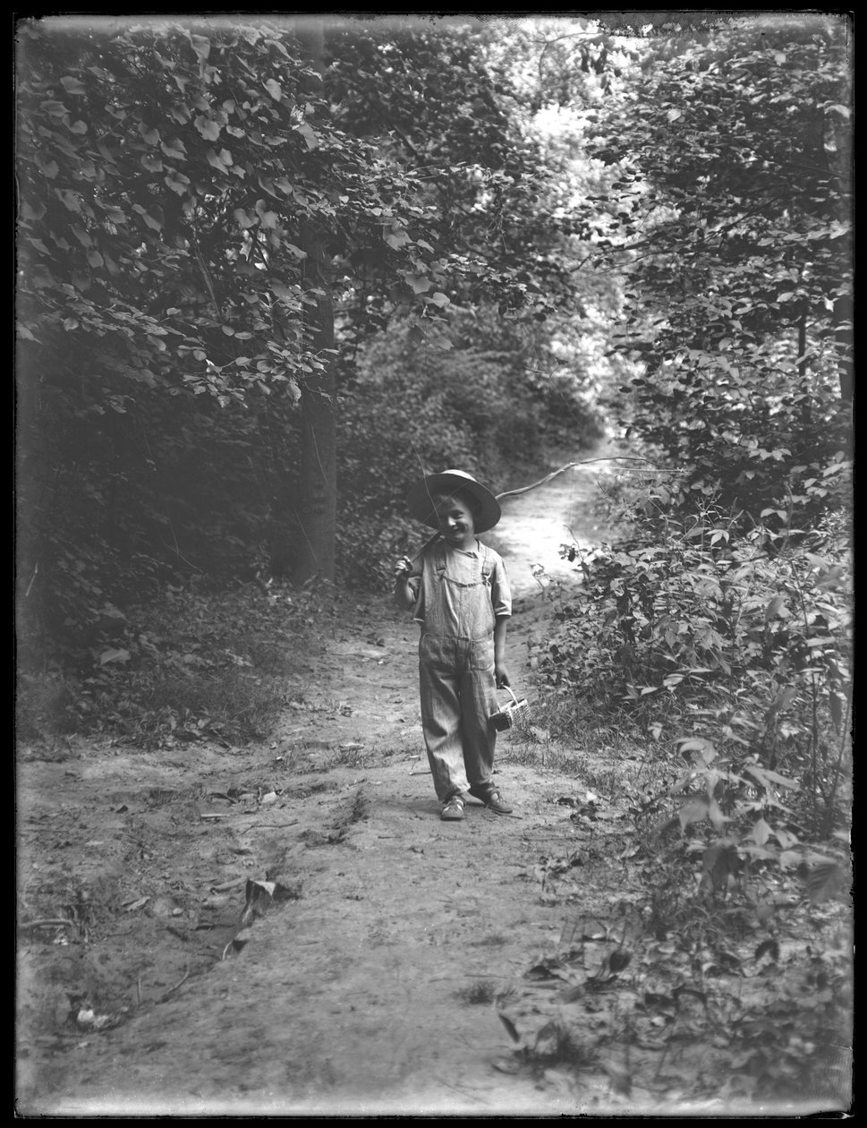 William Gray Hassler in Straw Hat and Overalls, Carrying Fishing Pole and Basket, Walking Down a Path in the Woods Alone by William Davis Hassler