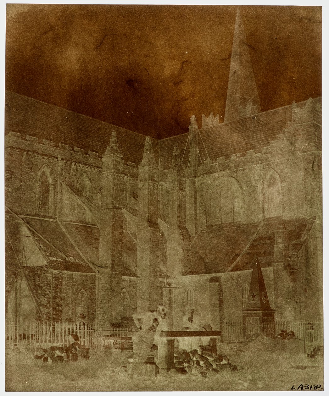 Two men pose in the graveyard of St. Patrick