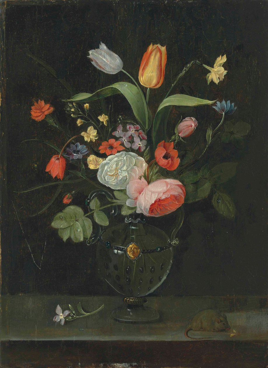 Roses, tulips, a daffodil and other flowers in a glass vase, on a stone ledge with a mouse by . .