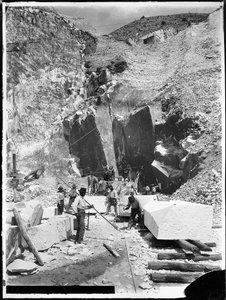 Alpi Apuane (Carrara). Quarrymen and blocks of marble being squared