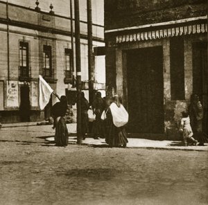 Women walking in the streets under the cover of a white flag during 