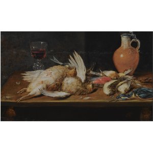 A still life with a robin, a kingfisher, partridges and songbirds, all on a wooden table, together with a glass and an earthenware jug
