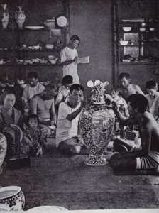 Porcelain decorators at work, in the noted Kinkosan Works at Awata, Kioto by American Photographer (after)