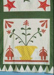 Quilt (detail) showing figures and flowers