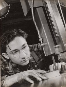 Man wearing glasses working with an industrial file