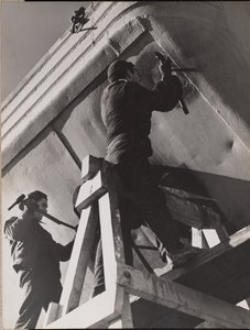 Two Men Work on the Underside of a Boat by Arnold Eagle