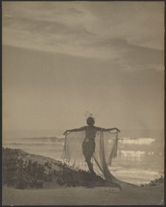 Back View of a Dancer Wearing a Sheer Costume at the Beach