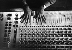 Hands on the mixing console