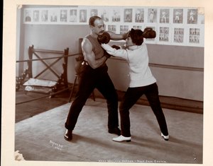 Edna Wallace Hopper posed in a boxing ring with Jack Cooper at his gymnasium at Broadway and 37th Street, New York, 1899