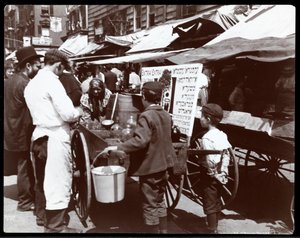 View of children buying drinks from a peddler on Hester Street, New York, 1898