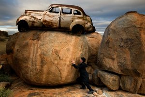 Man Pushing Car Boulder