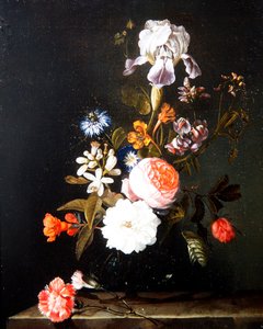 A Still Life of Flowers in a Vase Resting on a Ledge