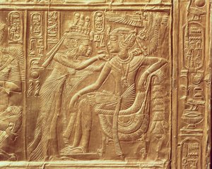 Detail from the little shrine of Tutankhamun depicting the Queen fastening a necklace round the king