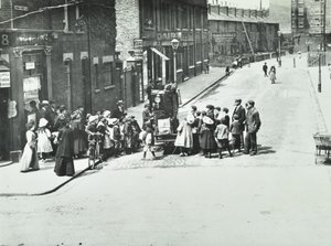 A Street Organist in Putney, London, 1886 by English Photographer
