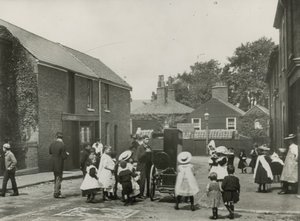 Crowd of Children Gather Around a Street Organ by English Photographer