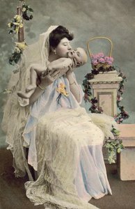 Mother kissing baby by English Photographer