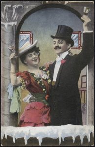 A well-dressed couple laughing