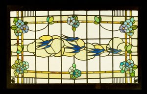 Arts and Crafts panel of a group of swallows before clouds in a border of stylised flowerheads by English School