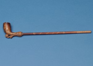 Cup tie pipe with bamboo stem and carved boot kicking a ball underneath (clay) by English School