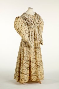 Dress printed with a flower and branch design on cream woven fabric with grid pattern in the weave, c.1830-35 by English School