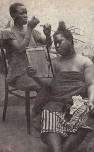 West African Woman Having Her Hair Done (b/w photo)