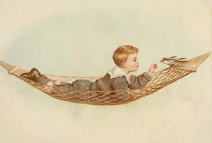 Boy lying in a hammock feeding a bird by European School