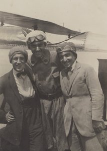 Portrait of Three Men Smiling in Front of an Airplane