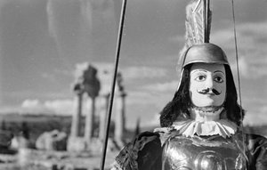 Sicilian Puppet. In the Background the Temple of Castor and Pollux in the Valley of the Temples in Agrigento