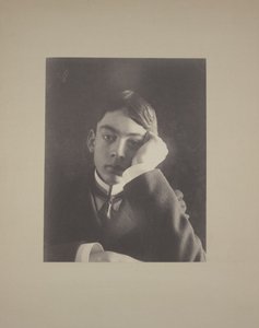 Boy in Suit with Hand Against Face