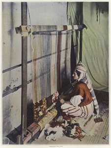 A Woman Weaving a Tapestry on a Loom in Tunisia