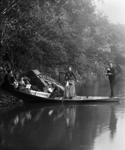 Group of friends, on a walk, resting on a boat by French Photographer