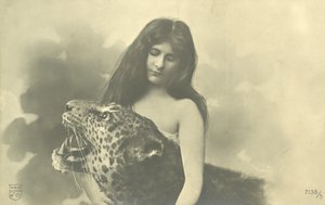 Long-haired girl with arms around stuffed leopard