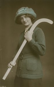 Young woman carrying a hockey stick over her shoulder by French Photographer